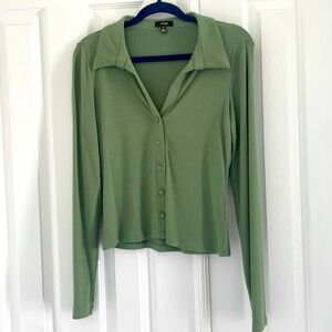Long sleeved, green top.